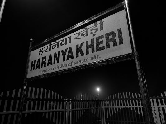 A black and white photo of a street sign